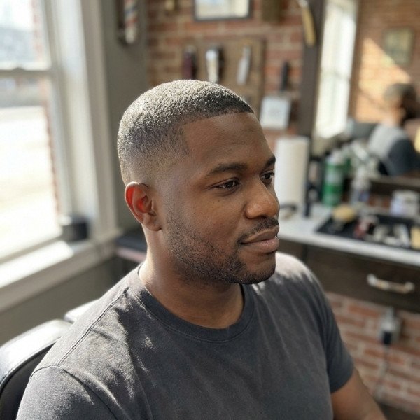 5 Guard Buzz Cut Black Male with a Sharp and Natural Look